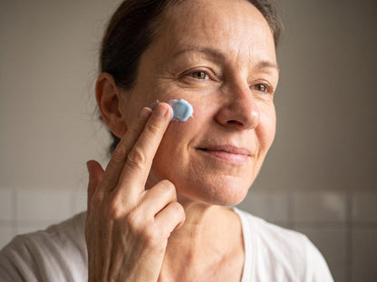Pressing the balm into the cheek