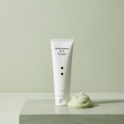 Matcha Hydrating Foam Cleanser tube beside a pile of foam