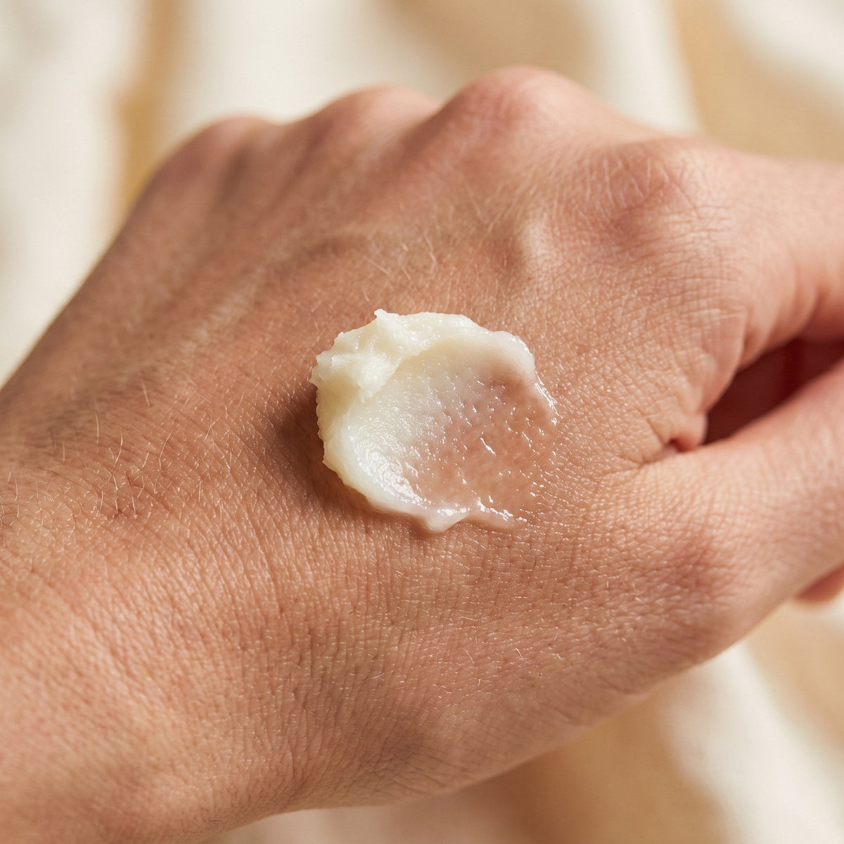 Tallow balm melting into the back of a hand