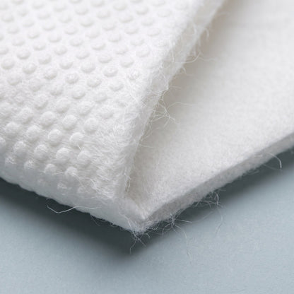 Disposable face towel: embossed side and smooth side