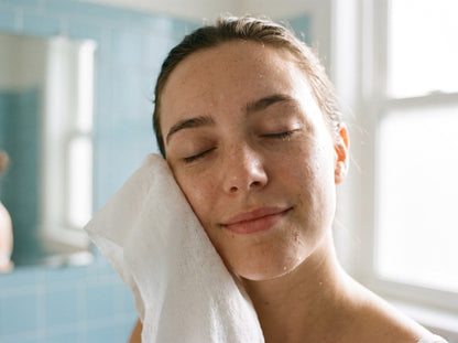 Patting the face dry with a single-use towel